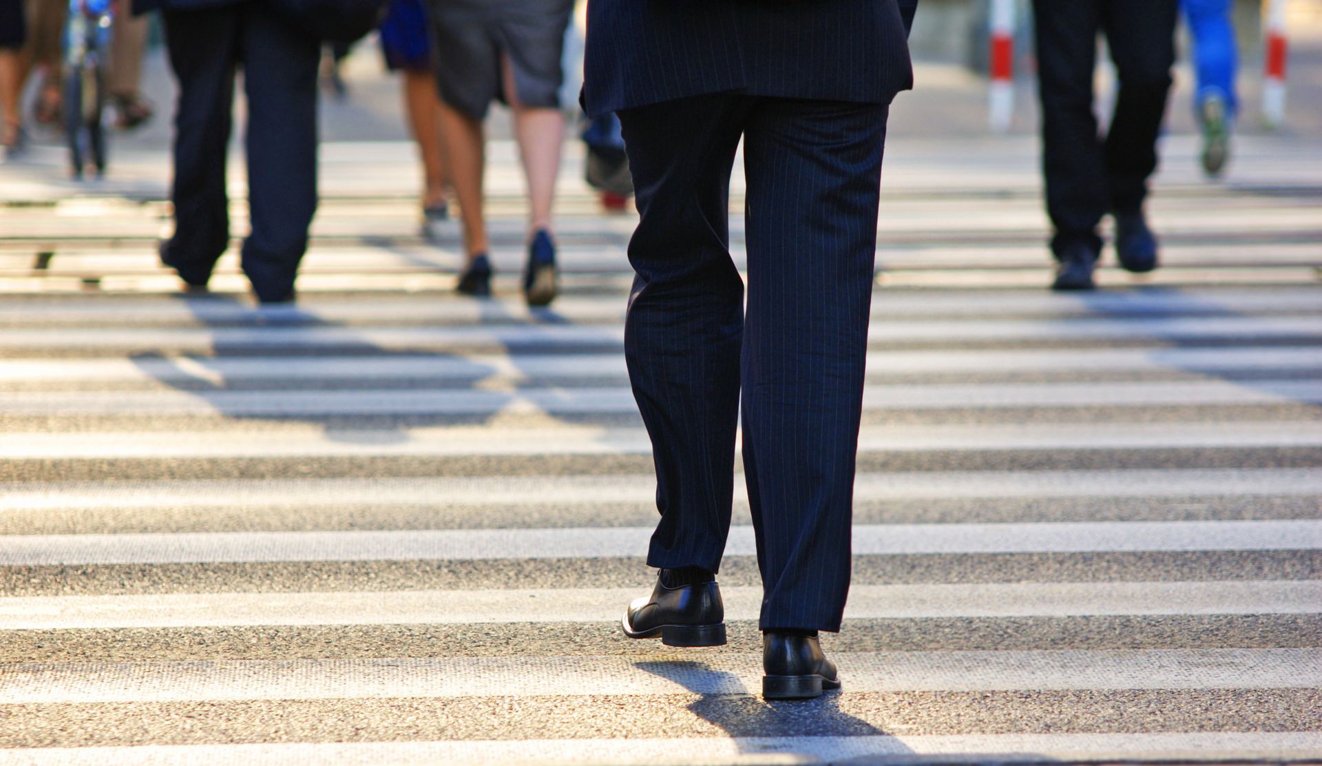 A group of people are walking across a crosswalk.