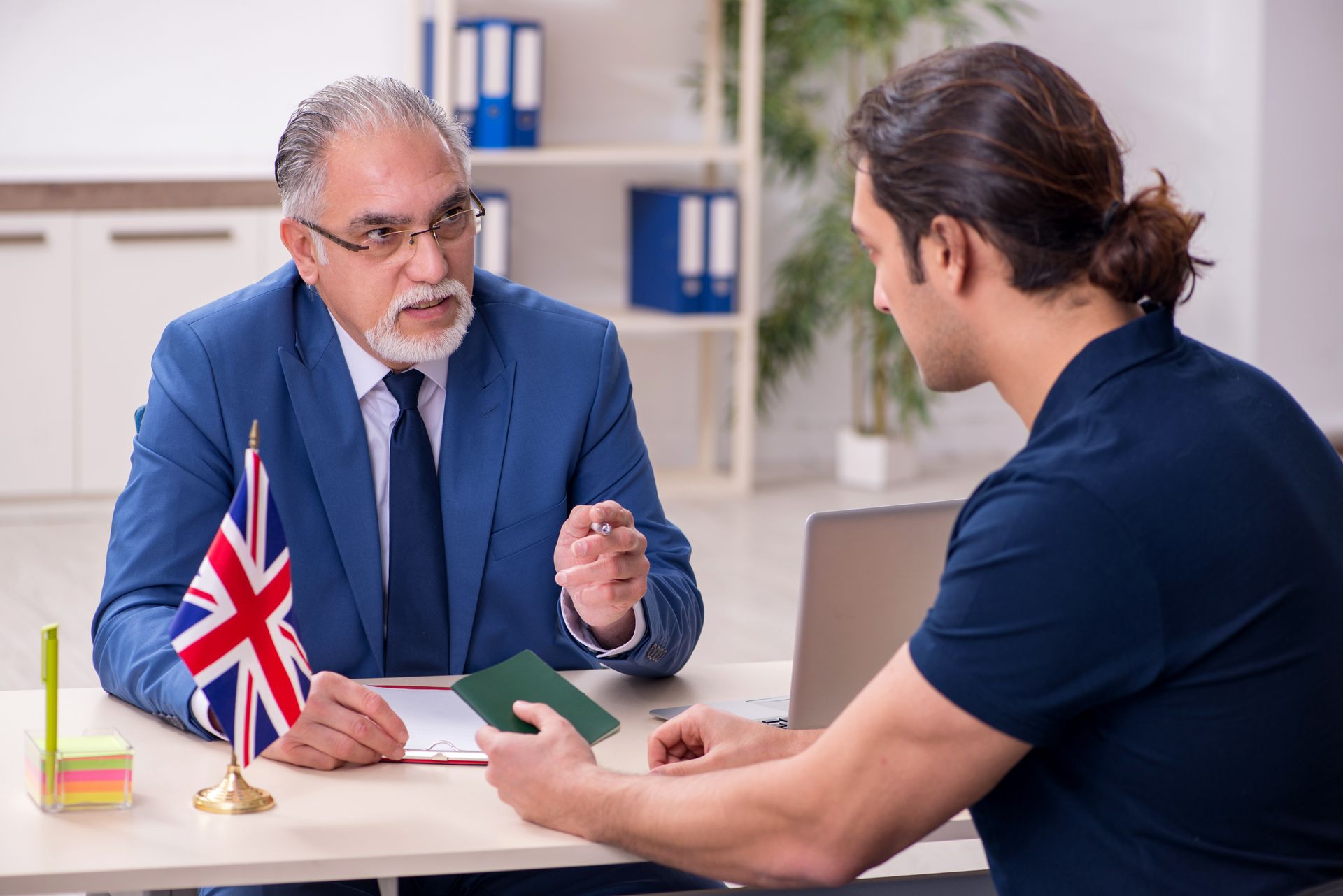 A visa application lawyer advising a client during an immigration meeting. A visa application lawyer advising a client during an immigration meeting.