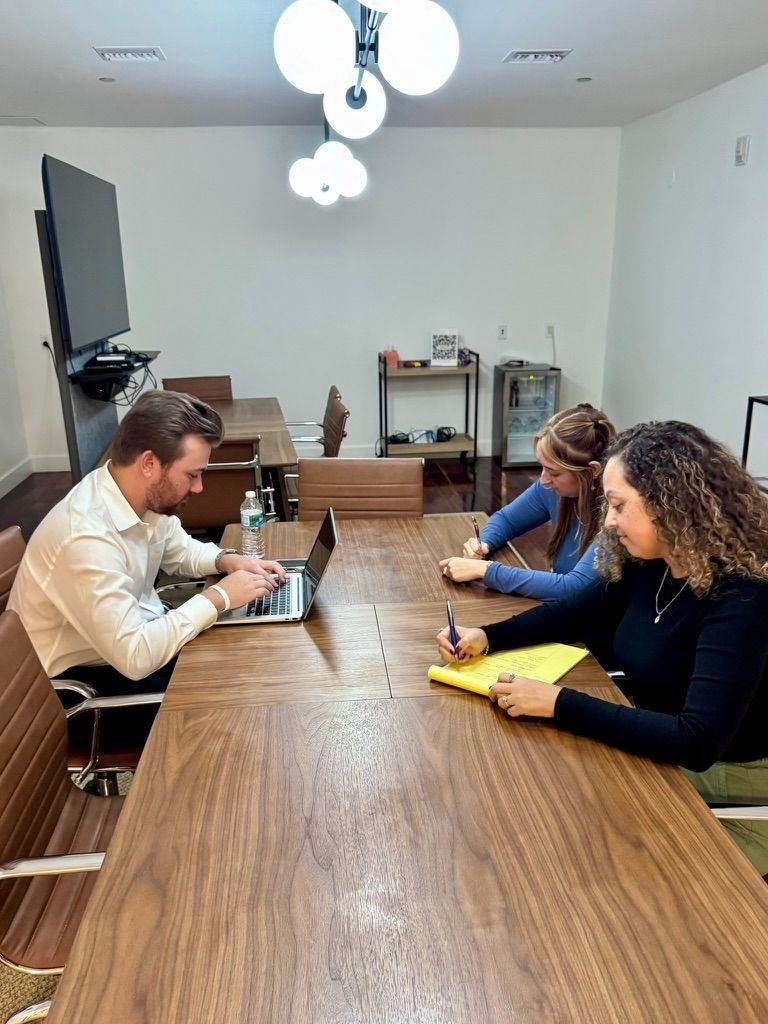 Handicapped businessman signs a document with the help of a personal injury attorney. Handicapped businessman signs a document with the help of a personal injury attorney.