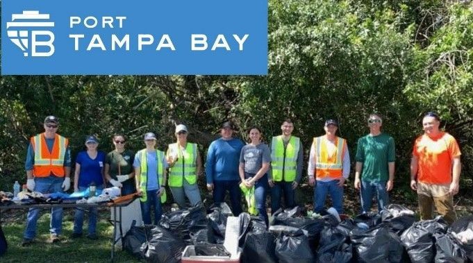 Port Tampa Bay volunteers stand in front of a line of collected trash bags after a community cleanup event. Port Tampa Bay volunteers stand in front of a line of collected trash bags after a community cleanup event.