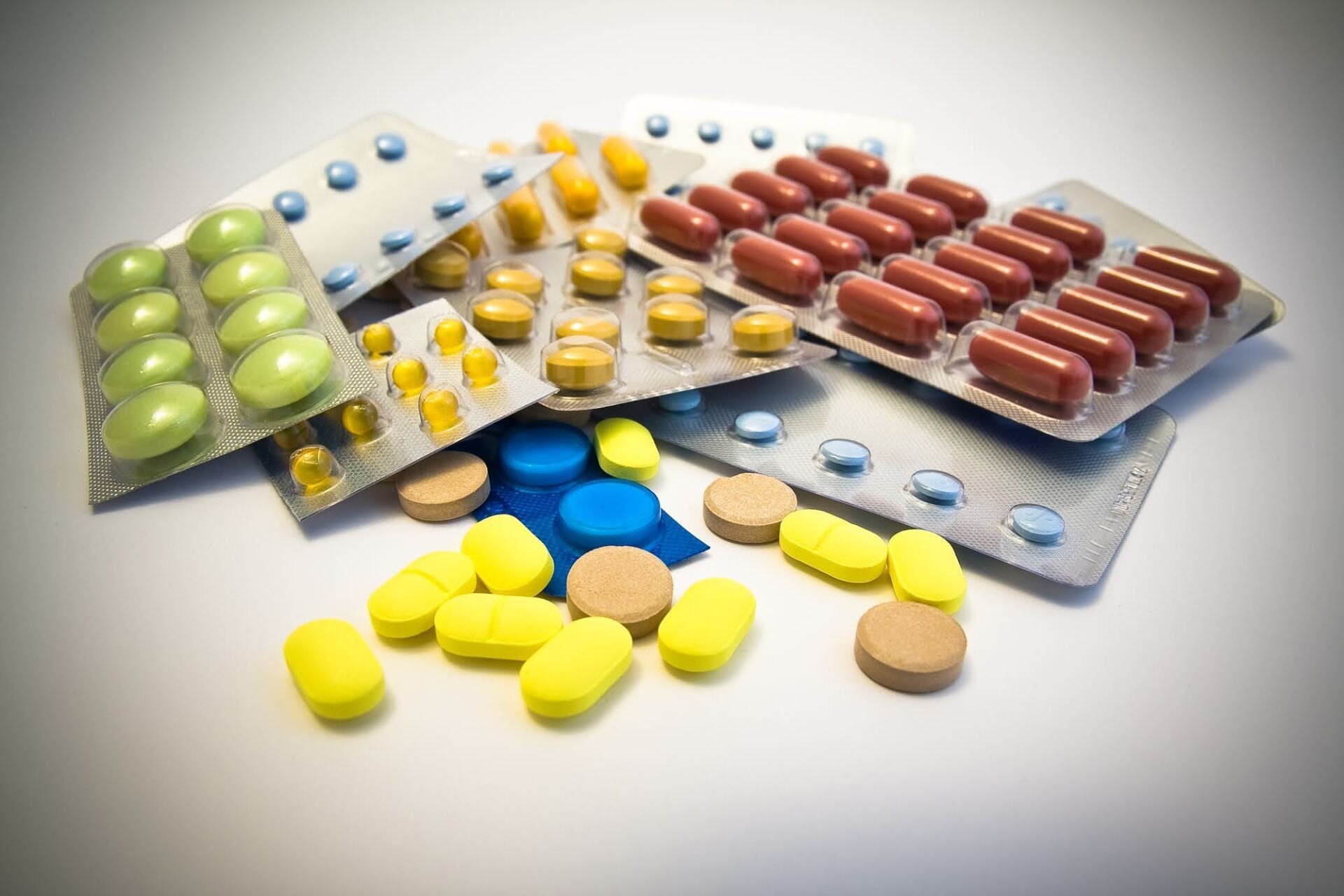 A bunch of different colored pills are stacked on top of each other