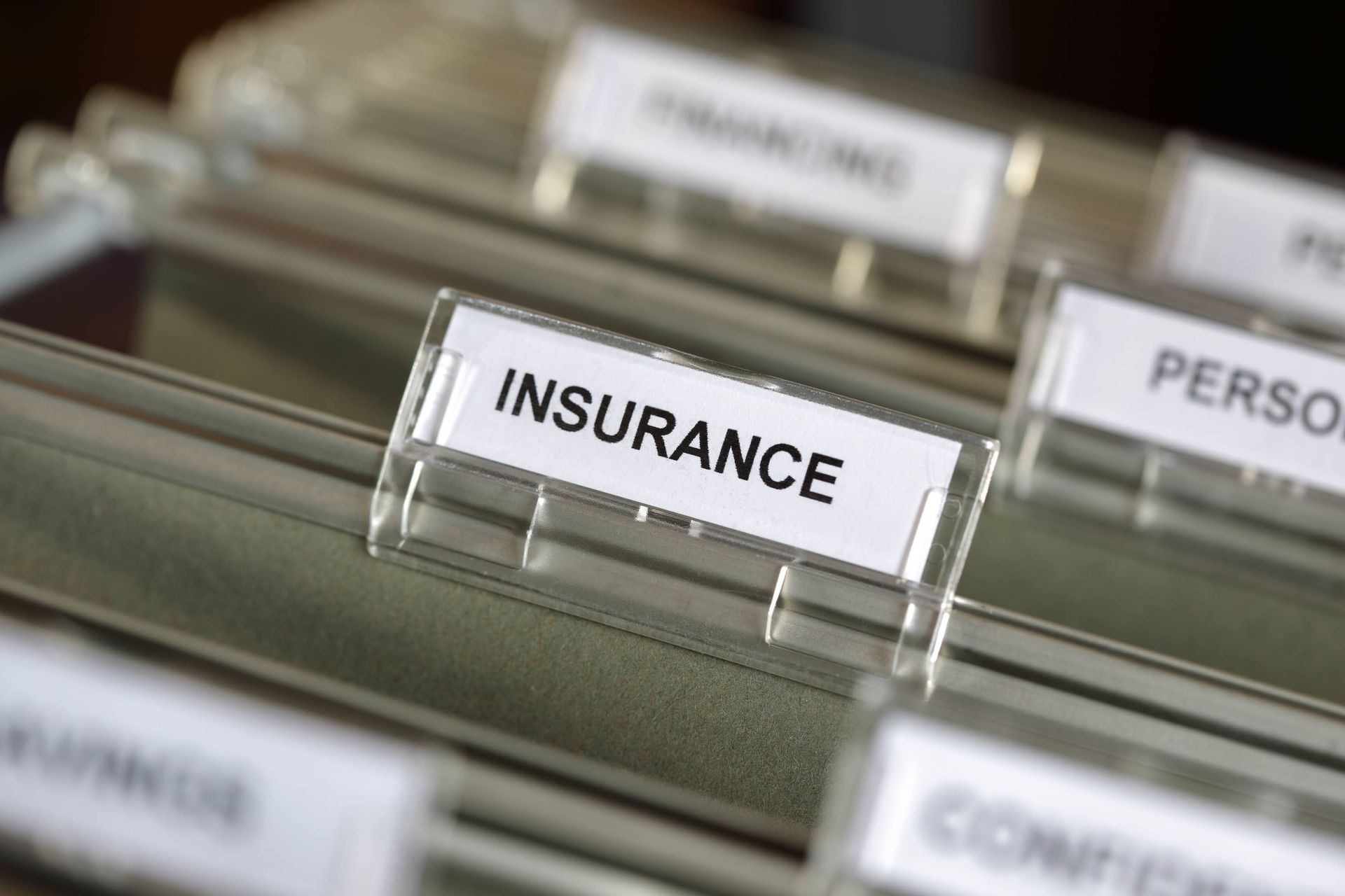 A close up of a binder with a label that says insurance