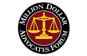 Logo for Million Dollar Advocates Forum. Black ring with white text surrounding a burgundy and gold scales of justice.
