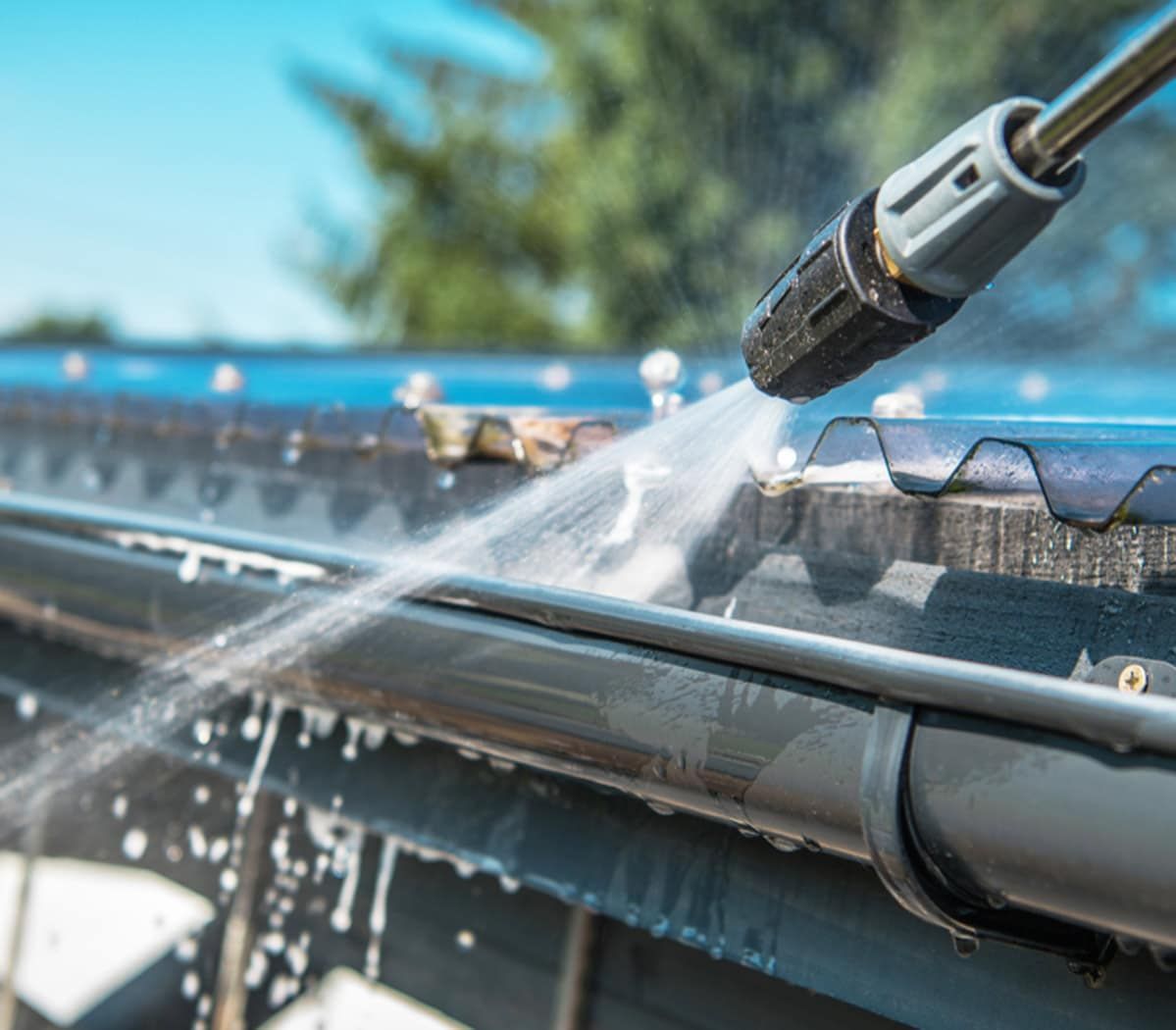 Power Washer Cleaning a Dark Gutter — Expert Plumbing & Solar Services Bathurst in Kelso, NSW