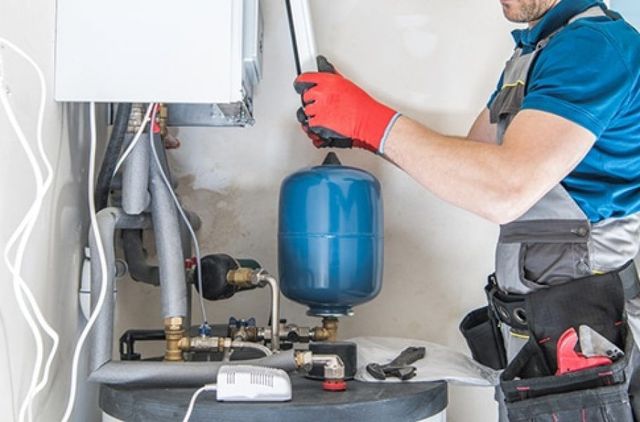 A Technician Performs Maintenance on a Boiler System — Expert Plumbing & Solar Services Bathurst in Orange, NSW