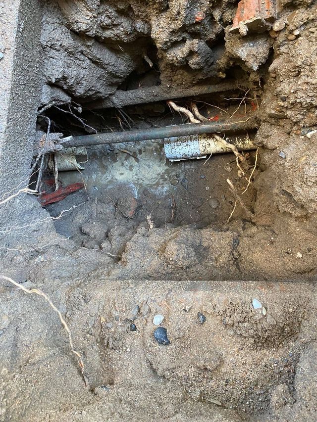 An Excavated Trench in the Ground Reveals Utility Pipes — Expert Plumbing & Solar Services Bathurst in Orange, NSW