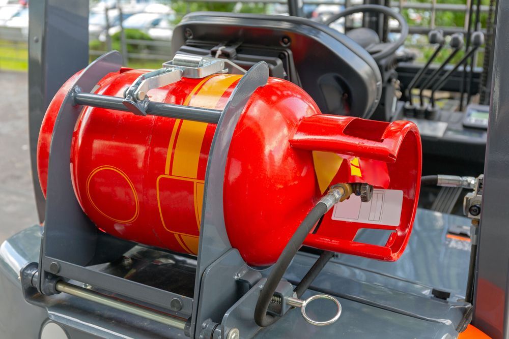 Red Propane Tank Secured on a Forklift — Expert Plumbing & Solar Services Bathurst in Kelso, NSW