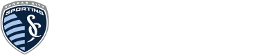 Blue-and-white shield sports club logo with a stylized figure and text around the edge