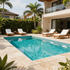 Modern villa patio with turquoise swimming pool, white loungers, and palm trees