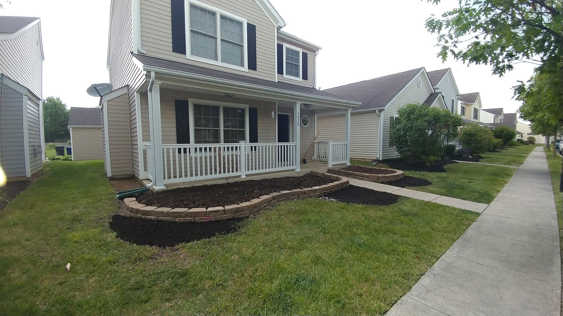 A house with a porch and a walkway in front of it