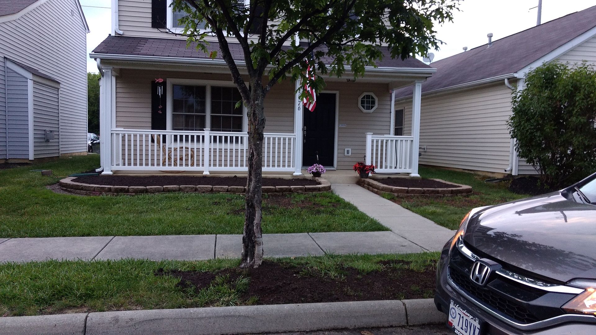 A honda crv is parked in front of a house