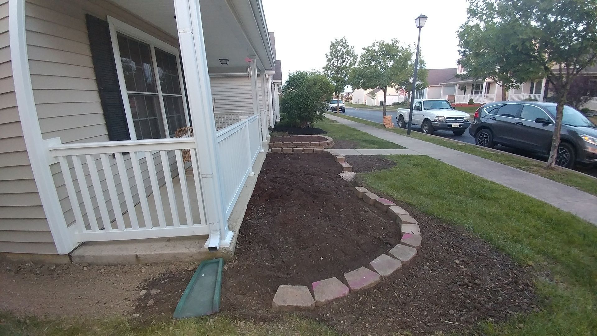 A house with a porch and a walkway in front of it