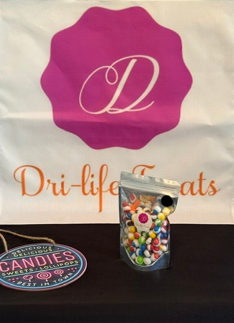 Dri-life Candies banner with pink logo and a jar of colorful candies on a black table