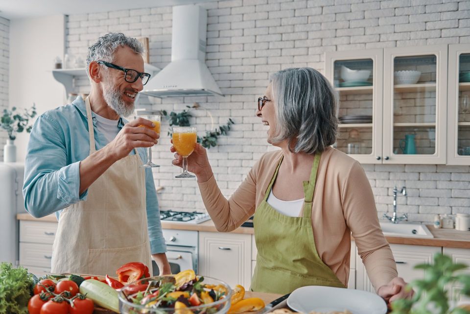 loving senior couple drinking and cooking