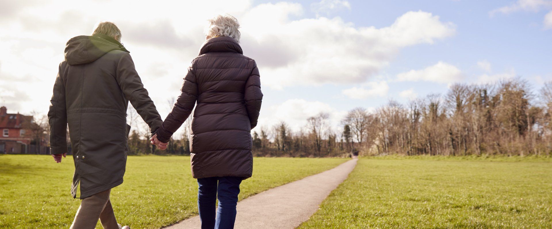 Rear view of loving senior couple holding hands