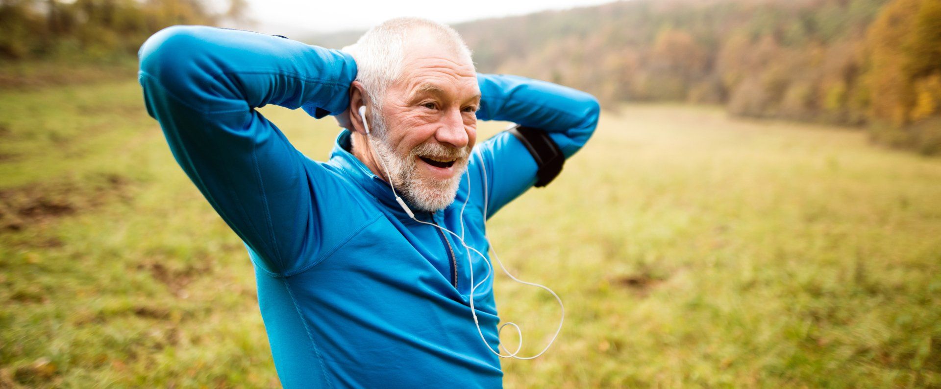 Senior runner with armband doing stretching