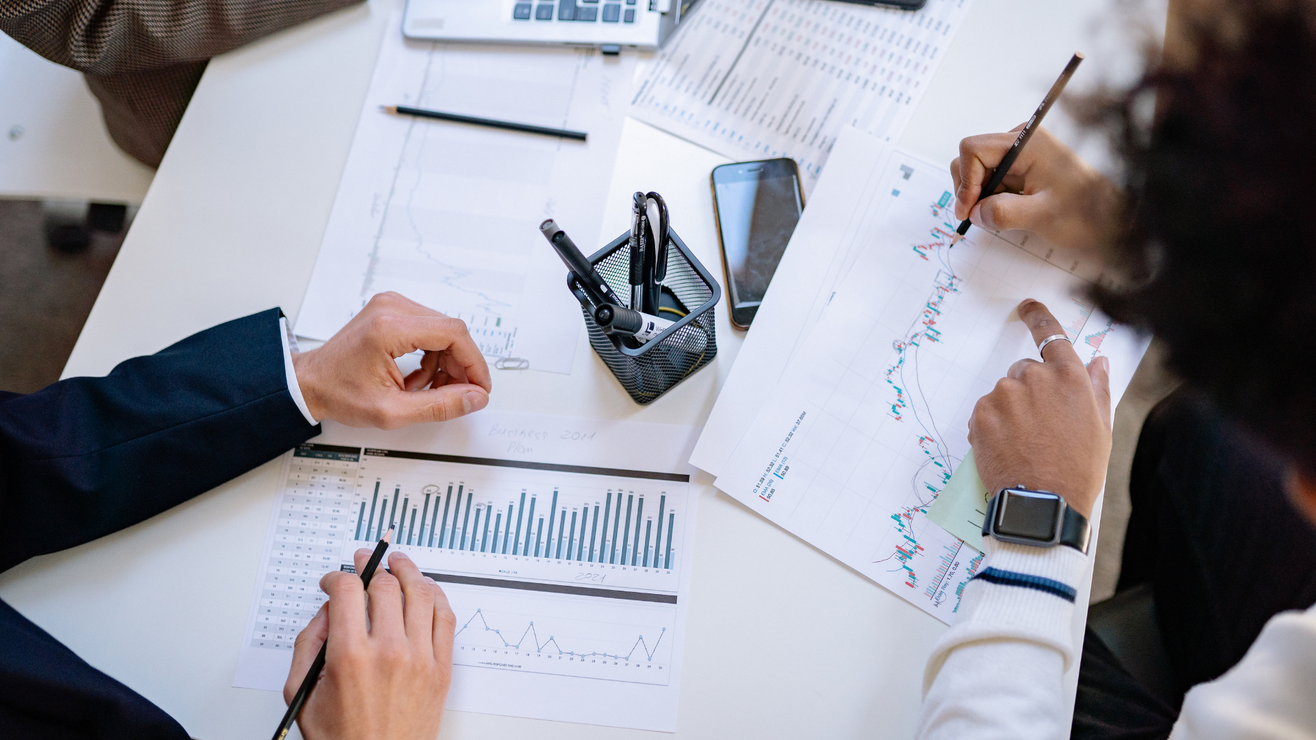 business people review stock charts