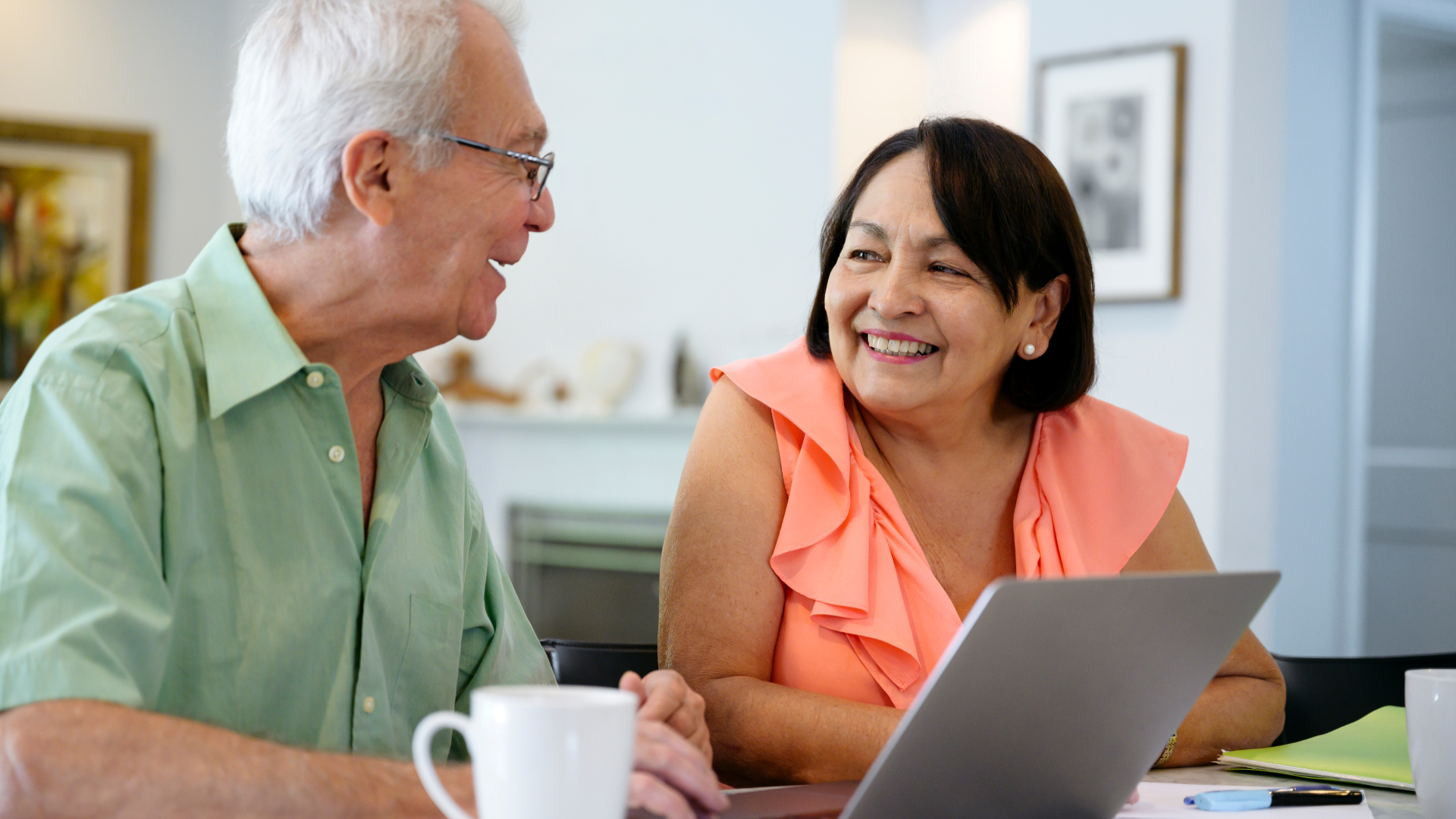 an elderly couple smiles at eachother