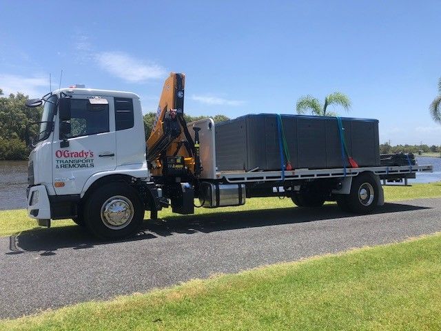 A Large Truck With a Crane on the Back is Parked on the Side of the Road — O'Grady's Transport & Removals in Lismore, NSW