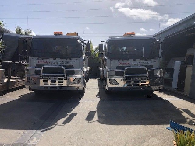 Two Trucks Are Parked Next to Each Other in a Parking Lot — O'Grady's Transport & Removals in Sydney, NSW