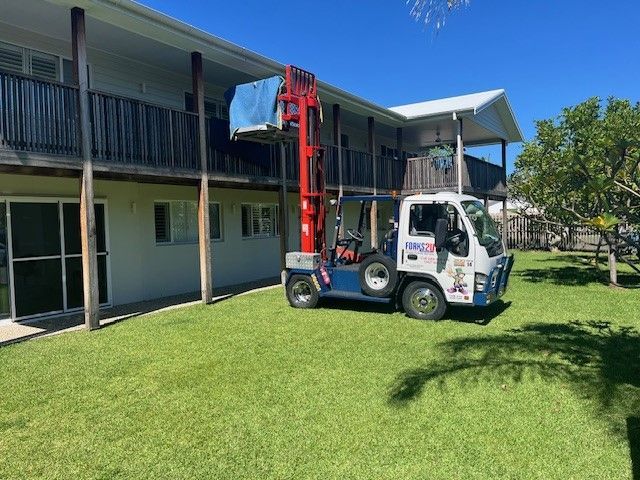 A Forklift is Parked in a Parking Lot in Front of a Building — O'Grady's Transport & Removals in Alstonville, NSW