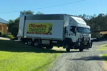 A Moving Truck is Parked on the Side of a Dirt Road — O'Grady's Transport & Removals in Alstonville, NSW