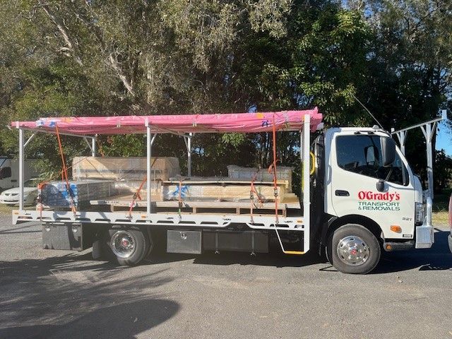 A White Moving Truck is Parked on the Side of the Road — O'Grady's Transport & Removals in Lismore, NSW