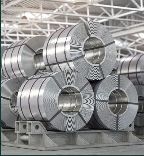 Stacked shiny steel coils in an industrial warehouse