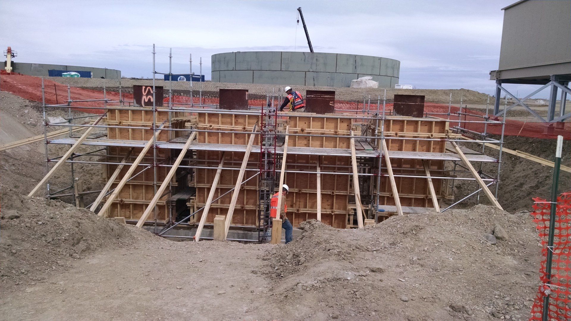A construction site with a large building in the background