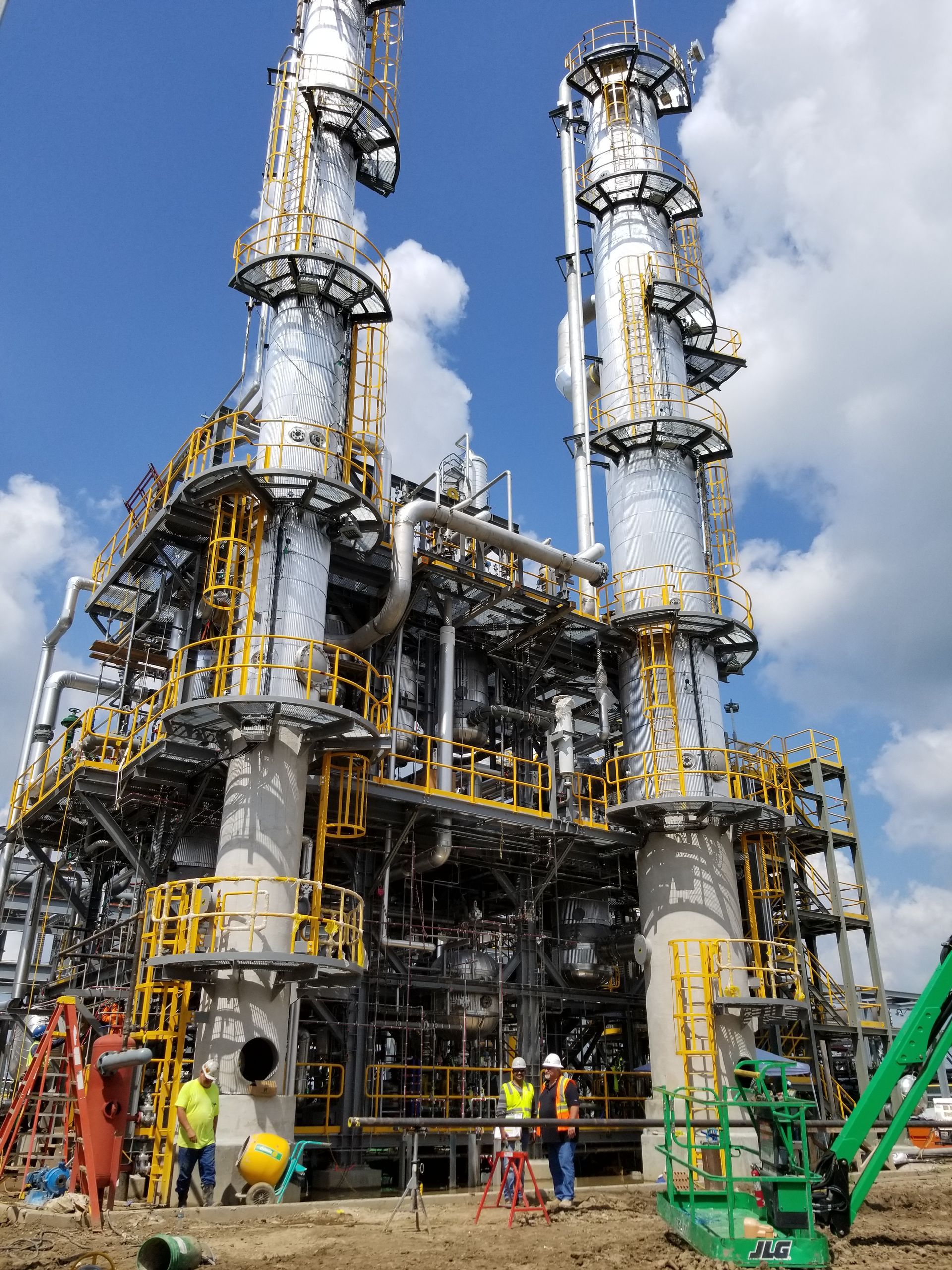 A large industrial plant with a blue sky in the background