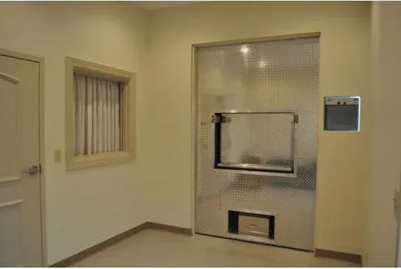 A room with a stainless steel door and a window.