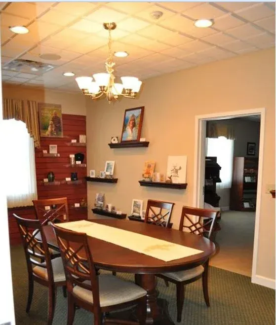 A dining room with a round table and chairs