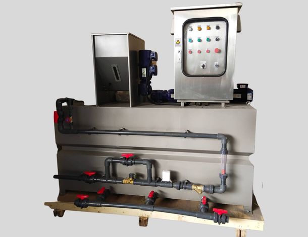 Industrial machine assembly with pipes, valves, and a control panel mounted on a metal frame