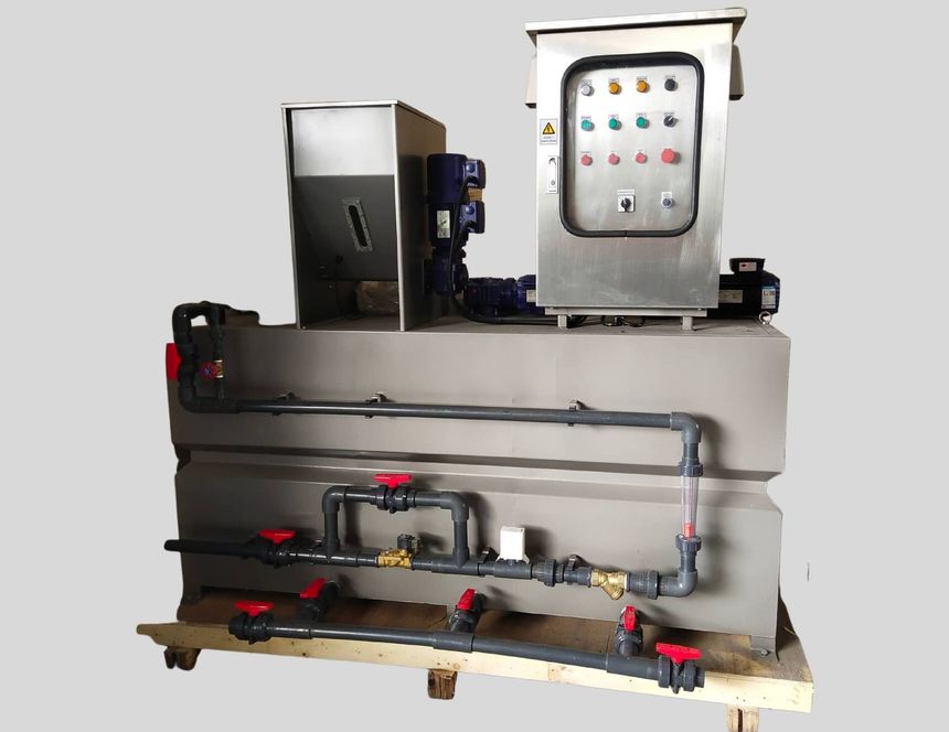 Industrial control panel with gauges, pipes, and red valves mounted on a metal frame