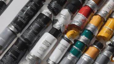 Assorted colorful cylindrical batteries stacked diagonally in rows