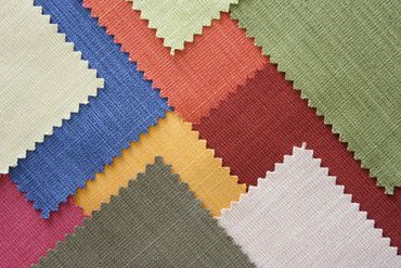 Colorful woven geometric pattern with overlapping blue, red, yellow, white, green, and pink sections
