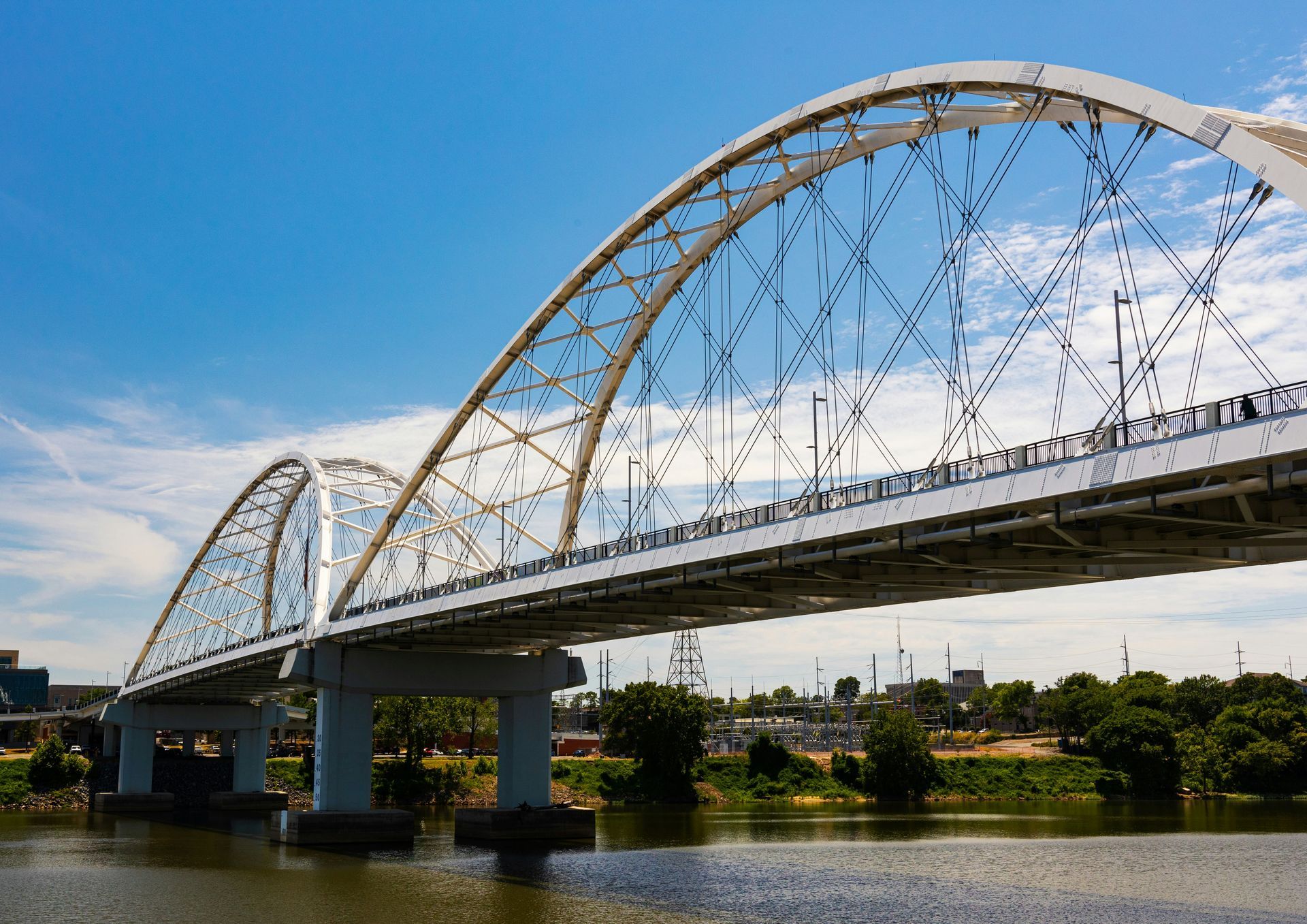A bridge over a river with a blue sky in the background.