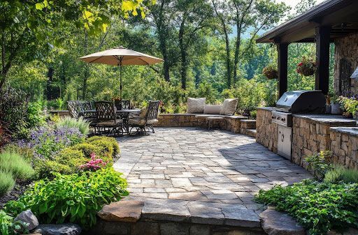 There is a patio with a table and chairs and an umbrella.