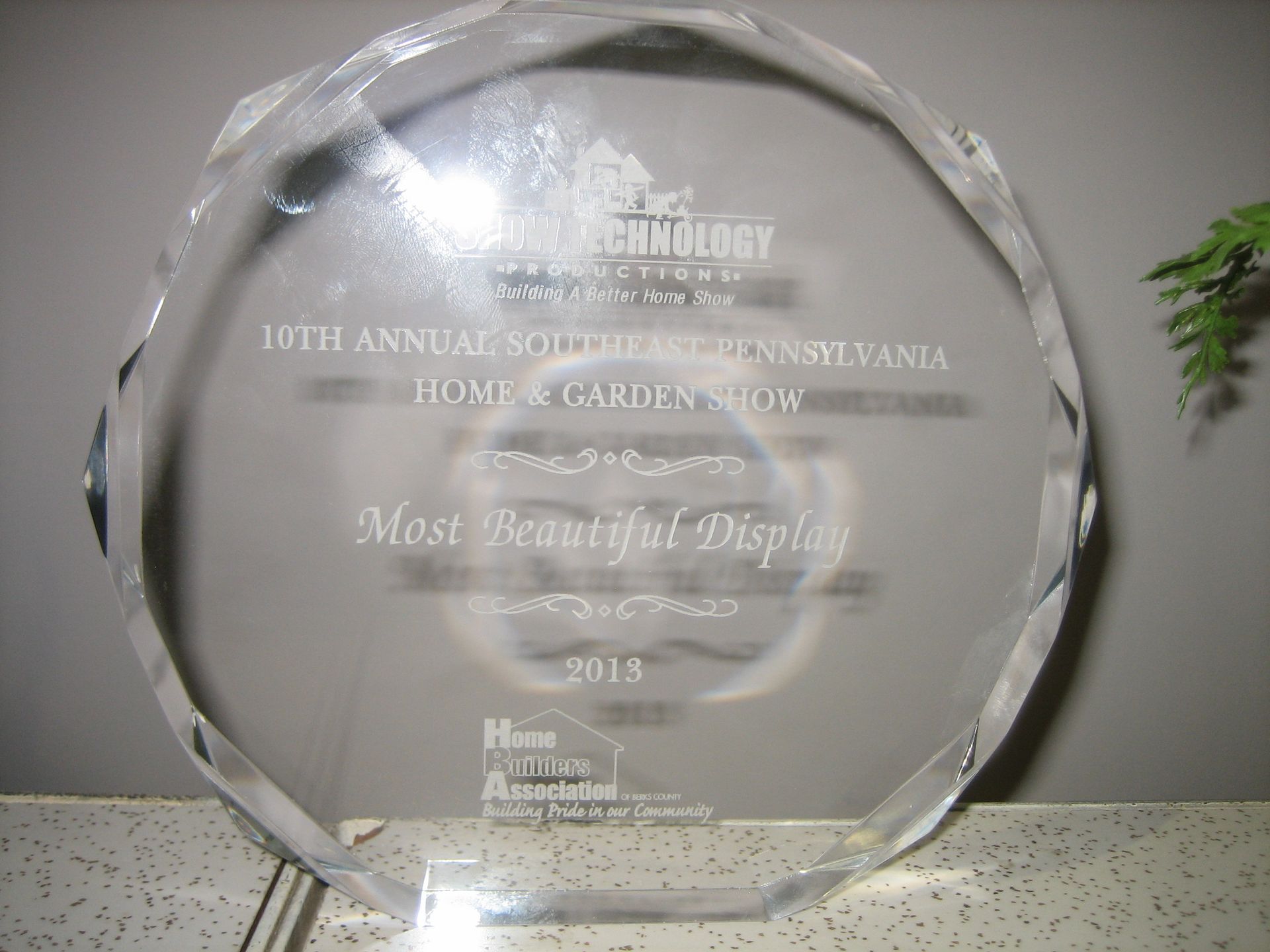 A clear glass plaque that says most beautiful display