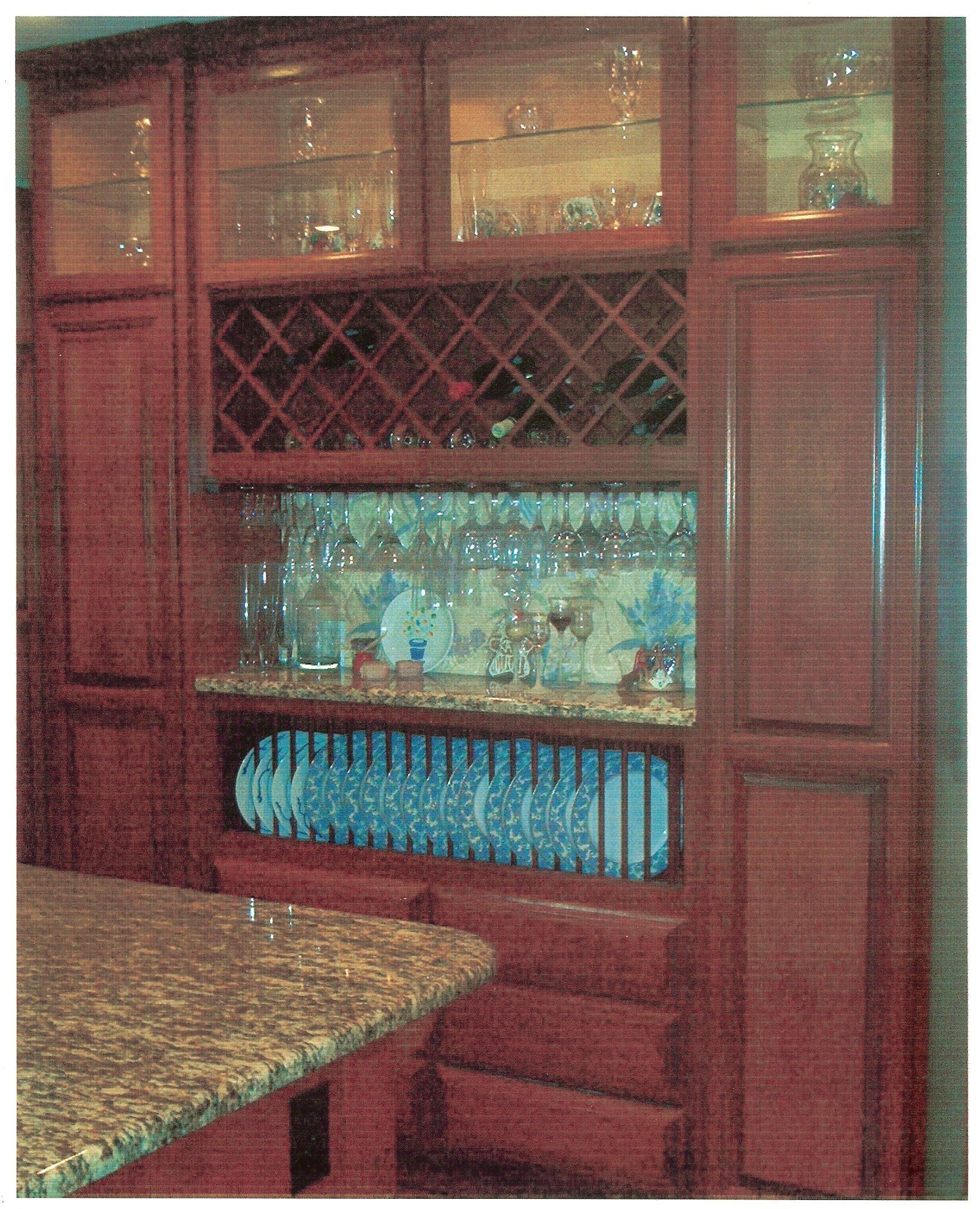 A kitchen with a wine rack and glasses on the counter