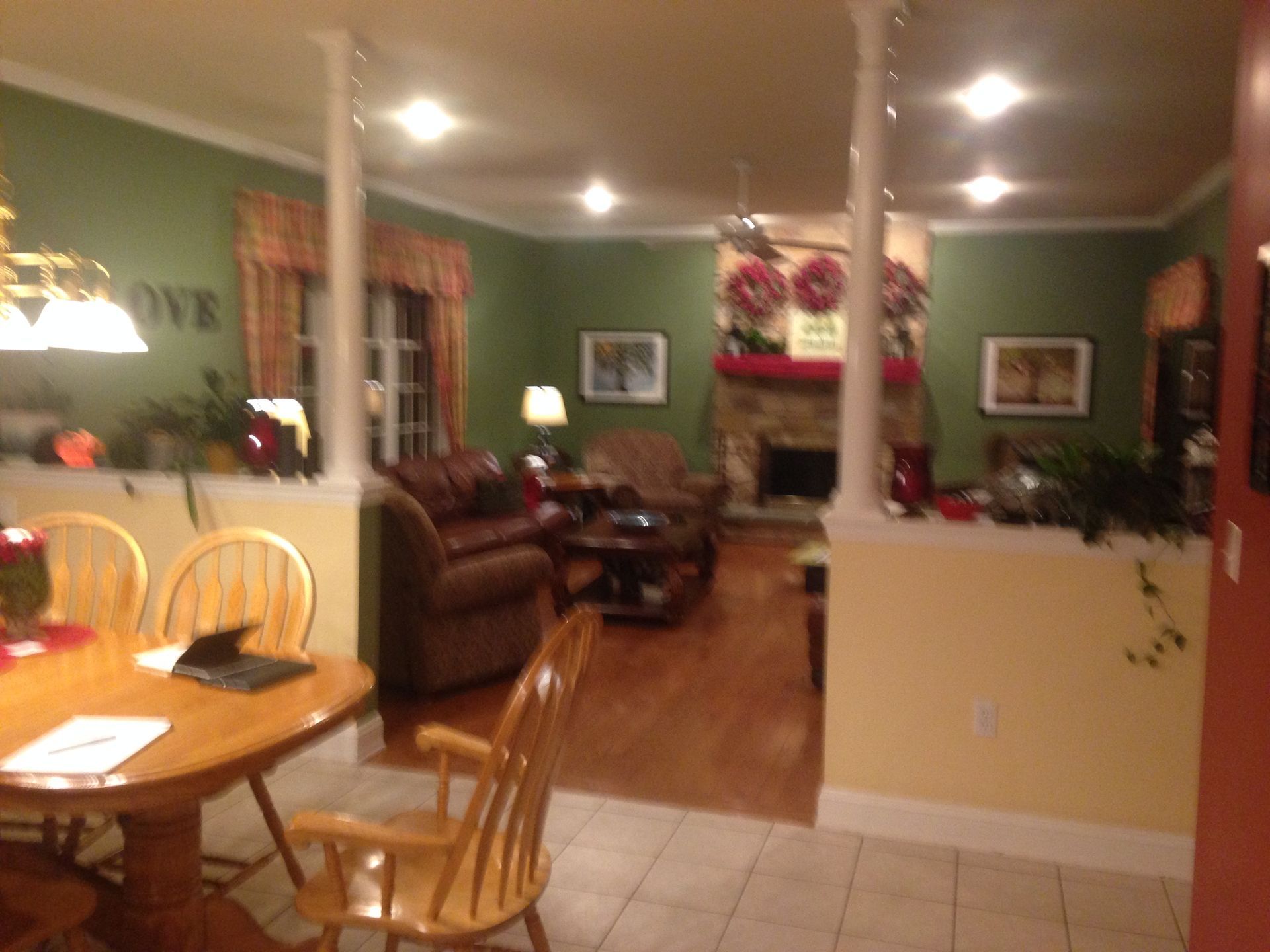 A living room with a sign that says love on the wall