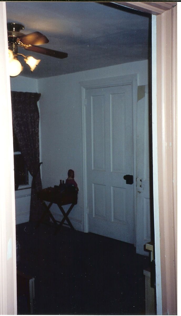 A room with a ceiling fan and a chair in it