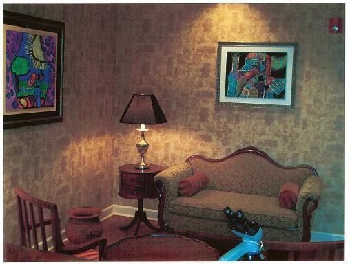 A living room with a couch a lamp and a picture on the wall
