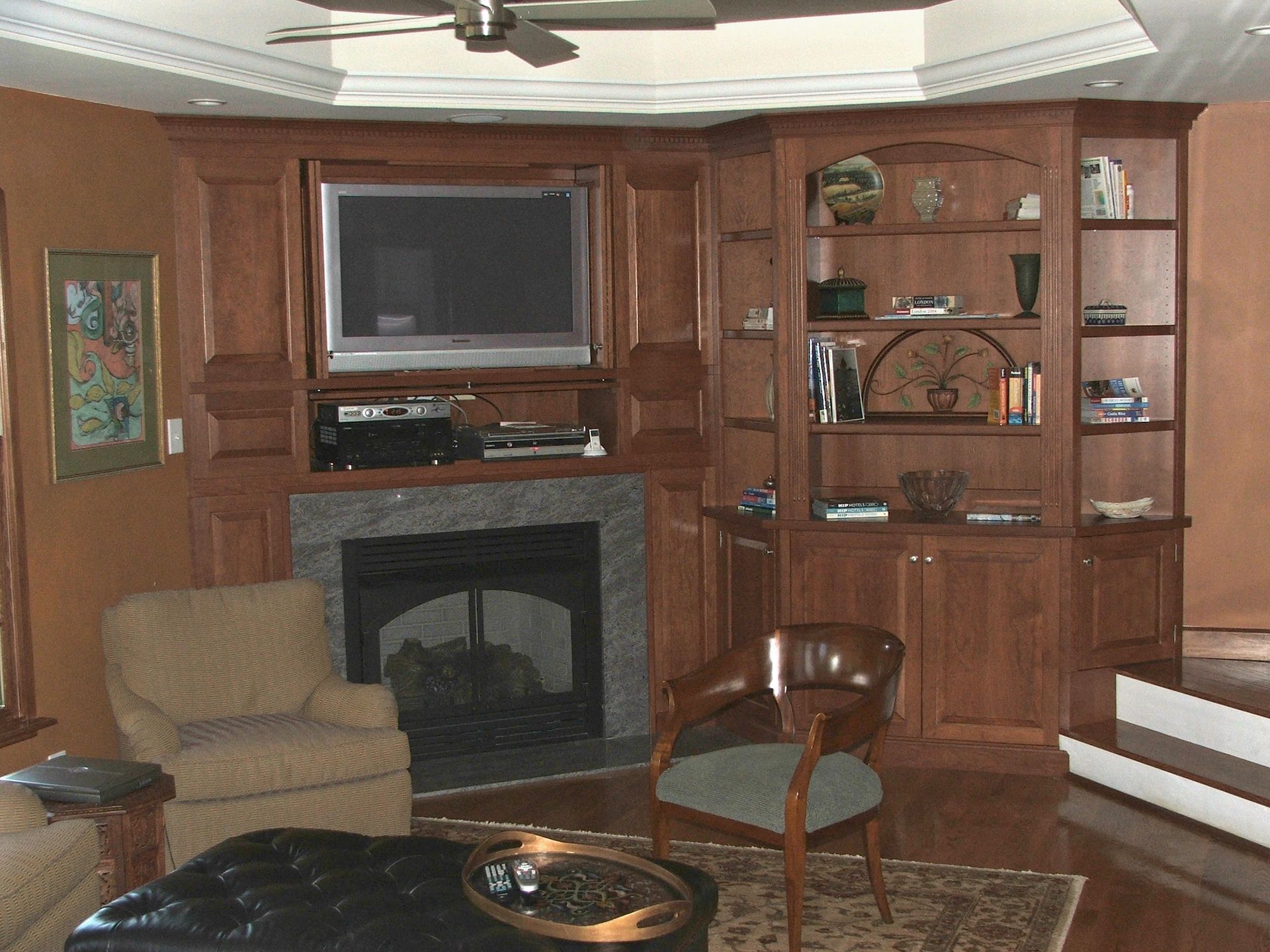 A living room with a fireplace and a flat screen tv