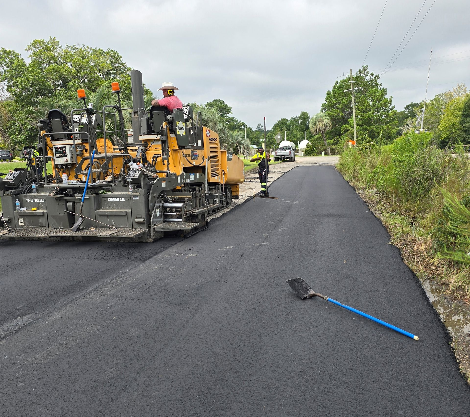 Man Standing On Road With Asphalt Paving — Jacksonville, FL — Pro Sealed Asphalt Inc. Man Standing On Road With Asphalt Paving — Jacksonville, FL — Pro Sealed Asphalt Inc.