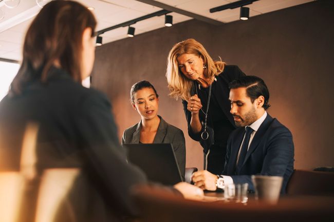 A group of business people are having a meeting in a conference room. A group of business people are having a meeting in a conference room.
