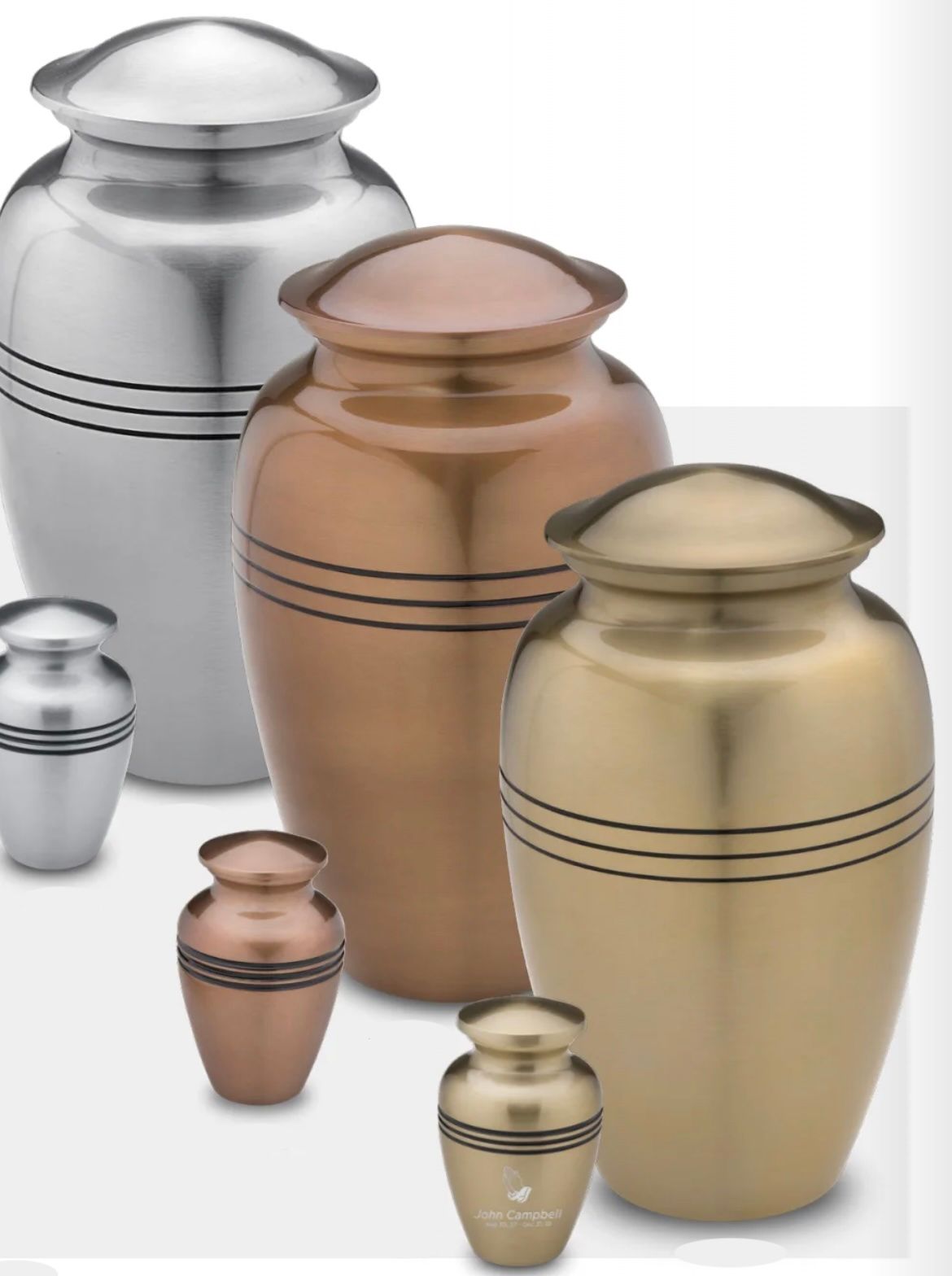 Assorted metallic urns in silver, copper, and gold tones, arranged in different sizes.