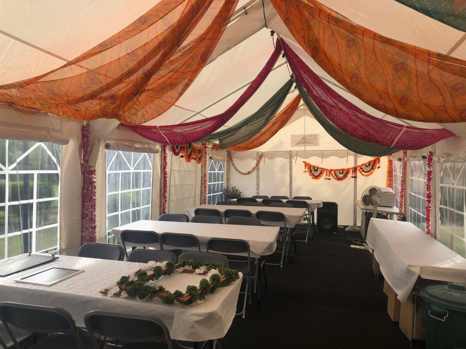A large tent with tables and chairs inside of it