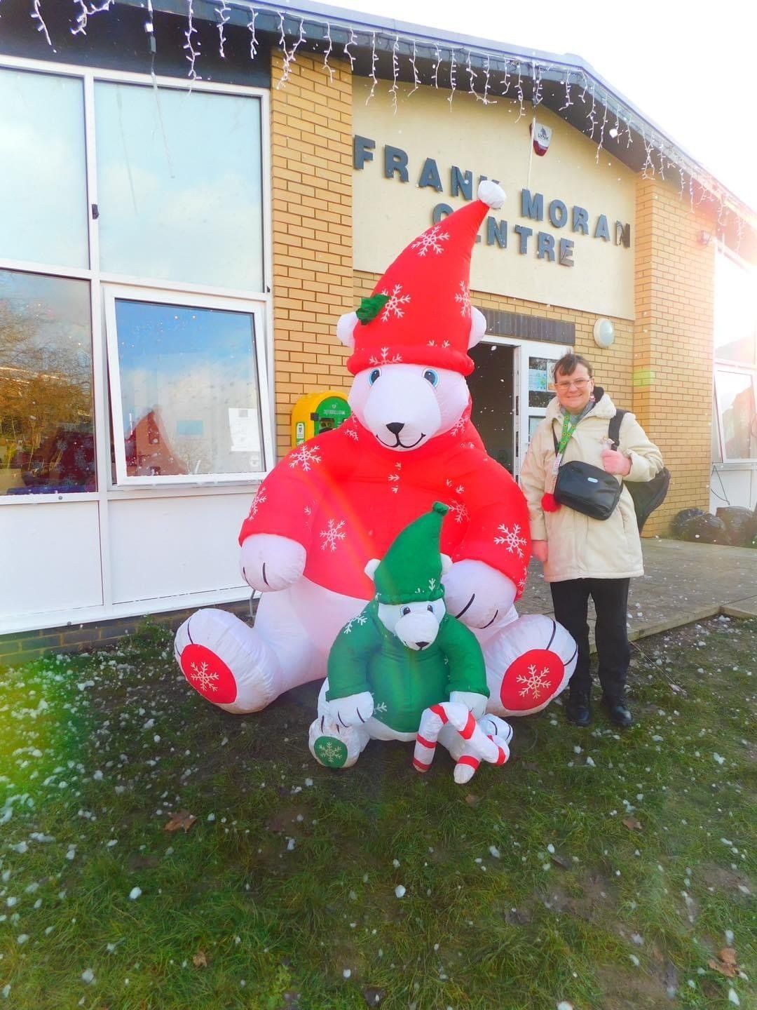 A woman stands in front of a building that says franci moran centre