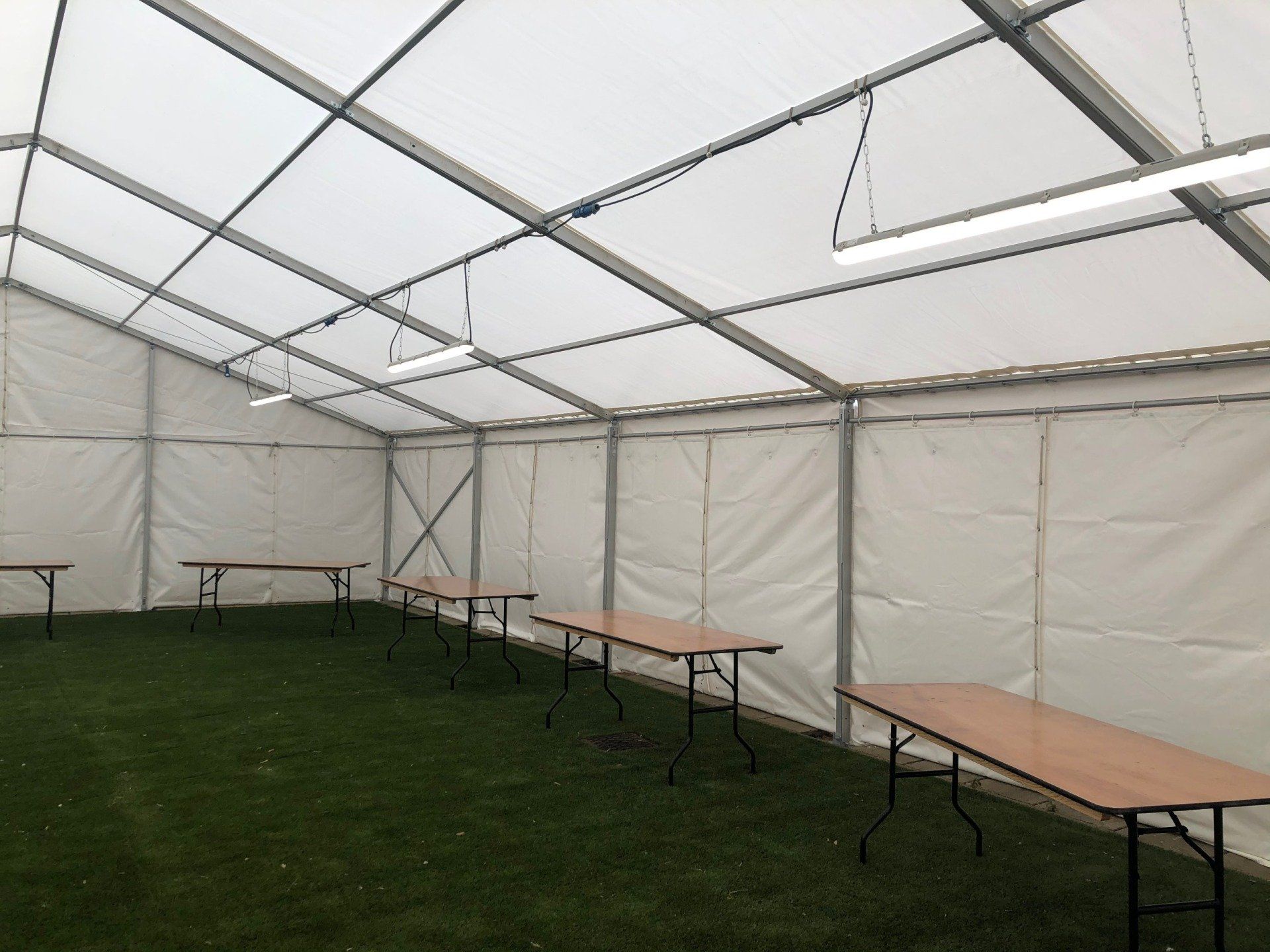 A large white tent with tables inside of it